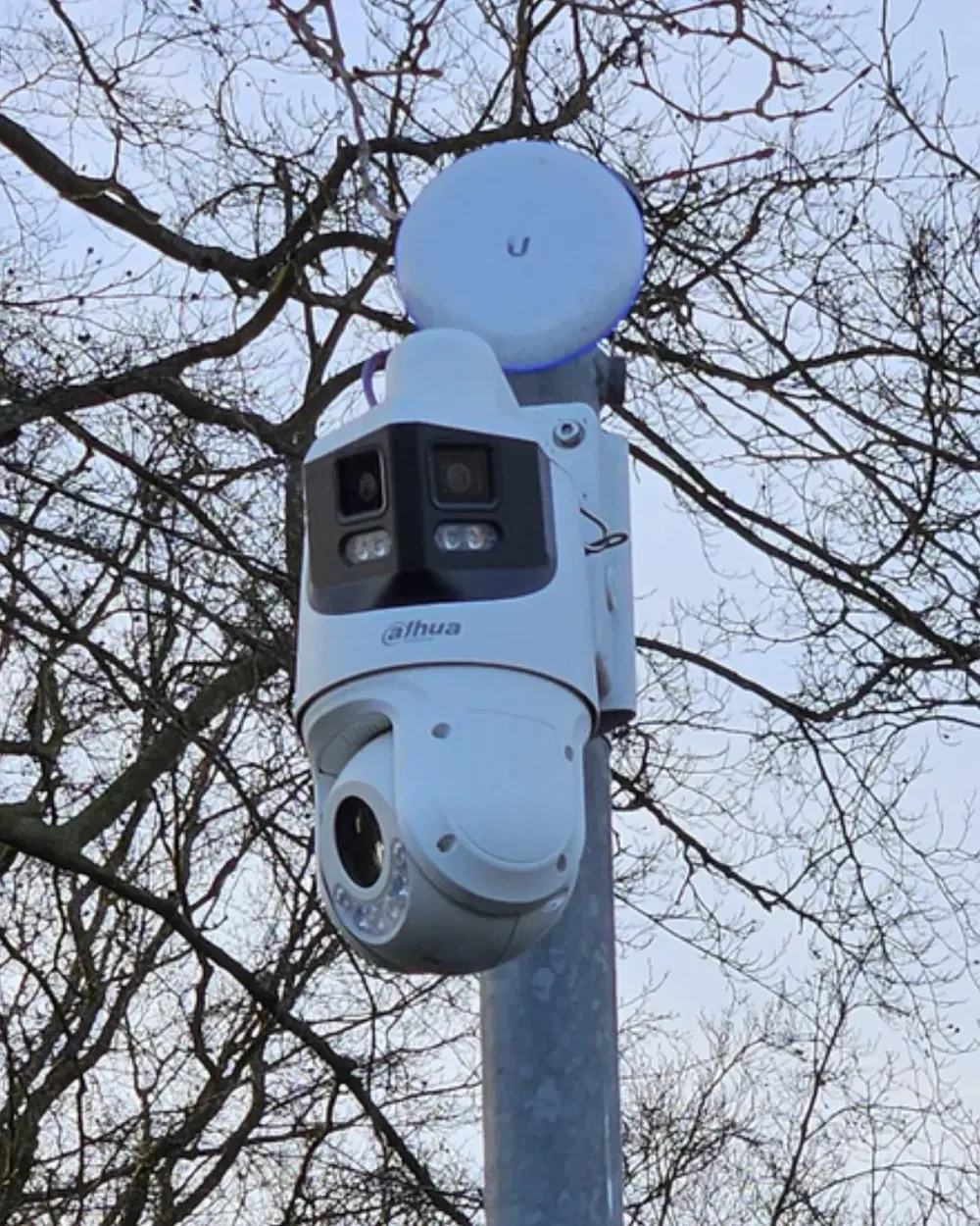 Camera met een draadloos verbindingspunt erboven op dezelfde paal
