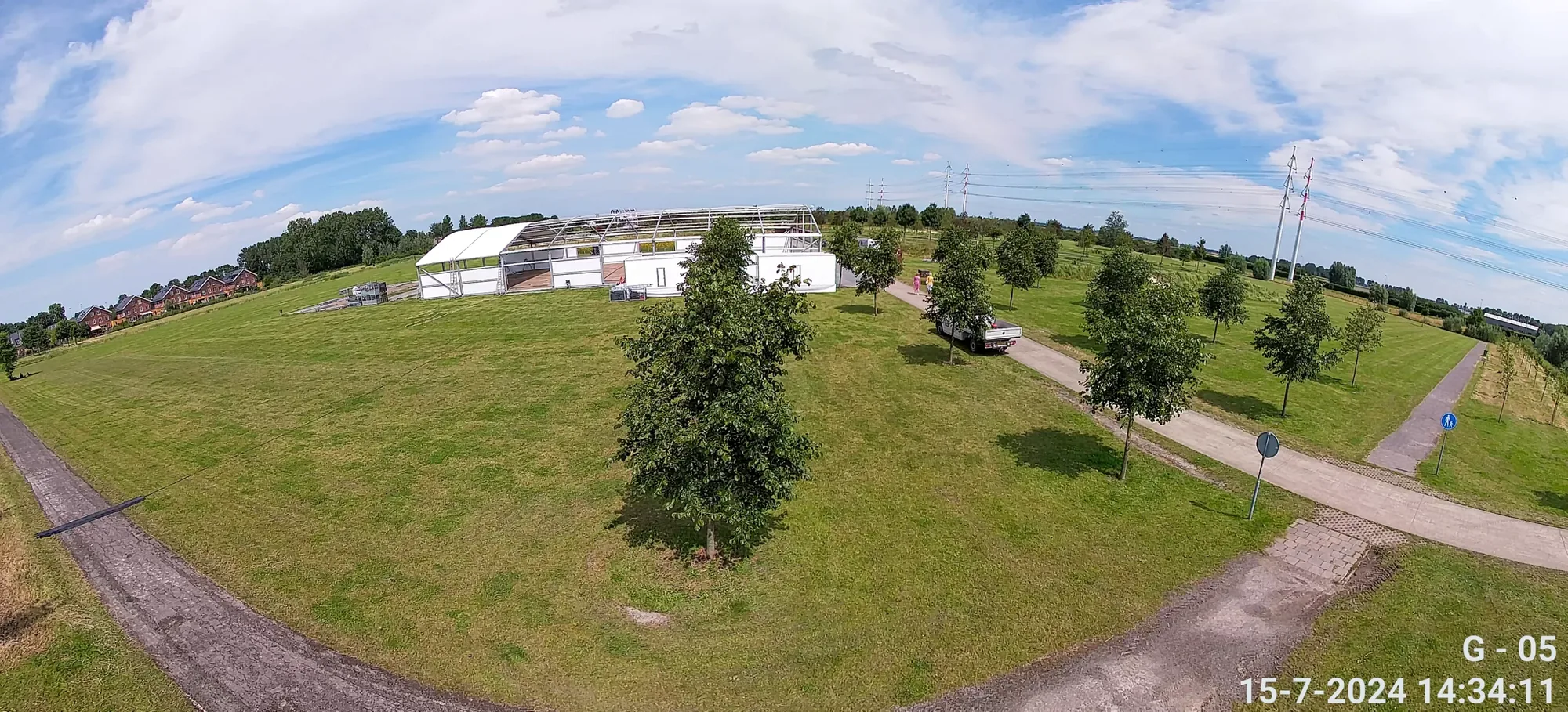 Camerabeeld vanaf een tijdelijke cameramast over een open terrein, met tijdstempel in beeld
